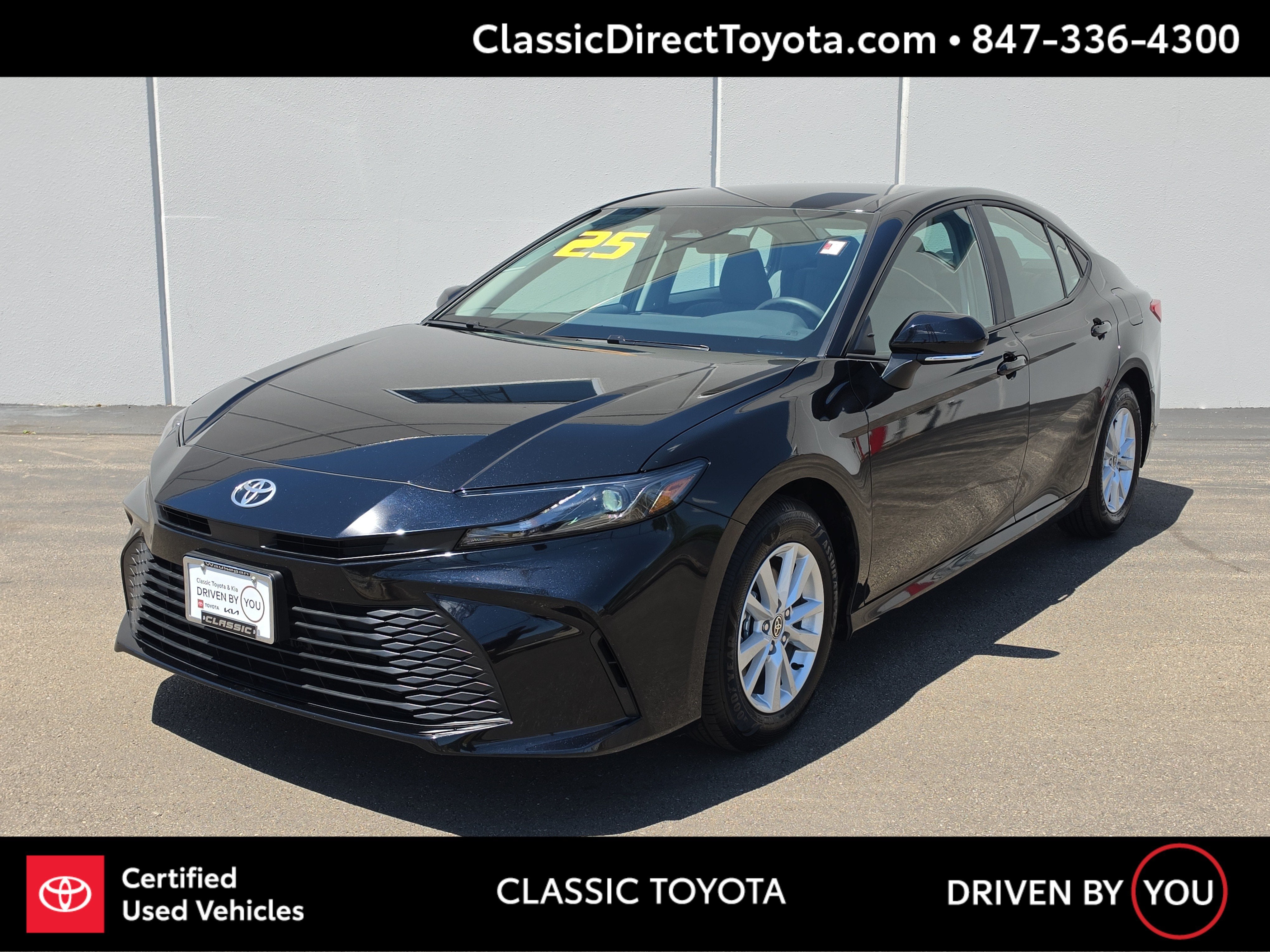 2025 Toyota Camry LE in Midnight Black Metallic — front three-quarter view