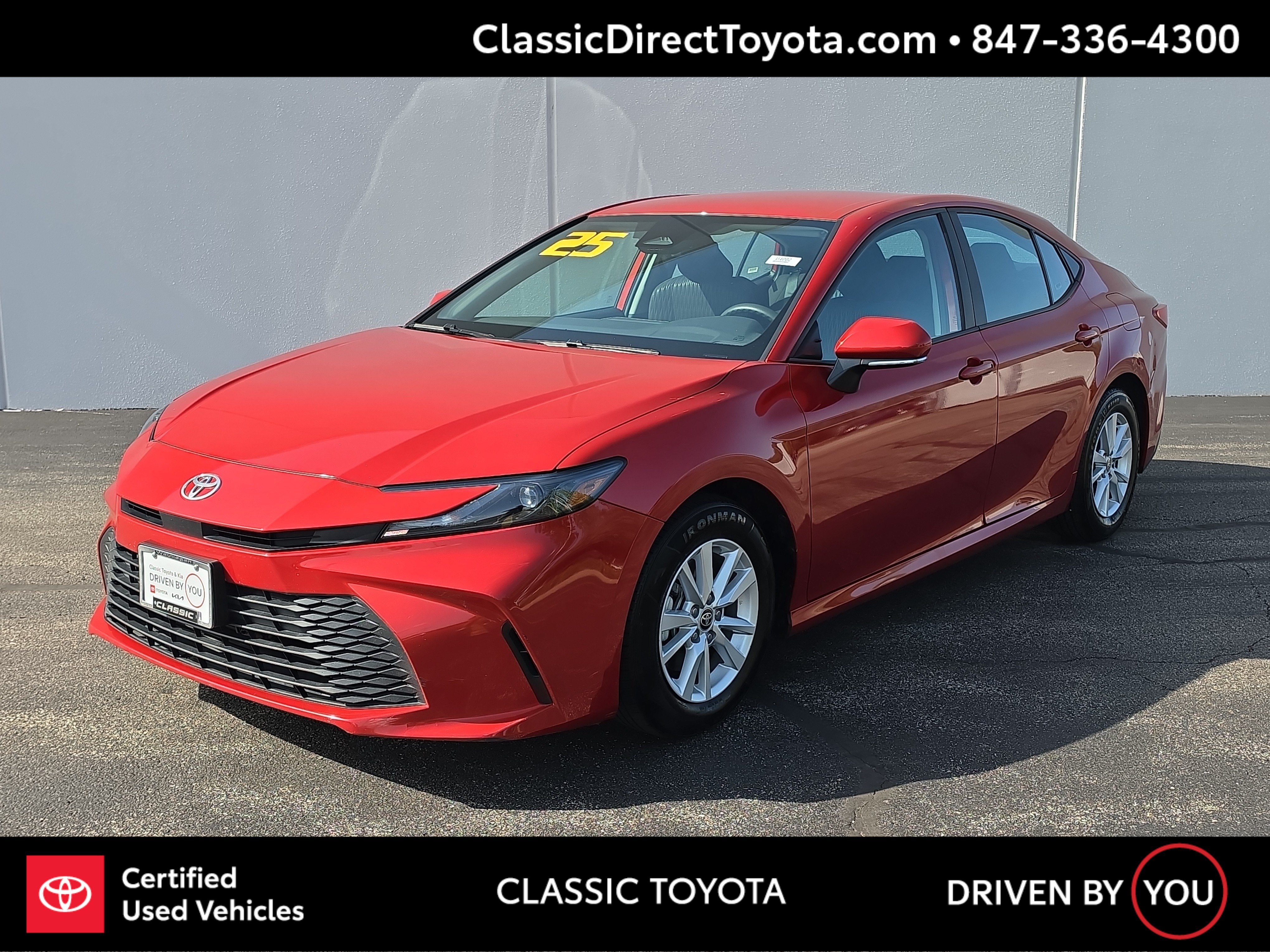 2025 Toyota Camry LE in Supersonic Red — front three-quarter view